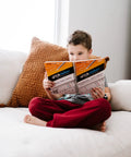 Child reading instructive workbook from Draw Circuits With Conductive Ink Pen Kit, 11 Electronic Sticker Modules, And A 27 Lesson Workbook