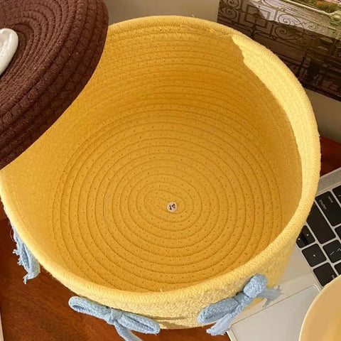 Inside view of Legit Handwoven Cotton Storage Basket With Snug Dustproof Lid in yellow, perfect for organizing bedroom clothes.
