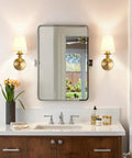 Onwecen Wall Sconces Set of 2, Modern Bathroom Light Fixtures, Brushed Gold flanking a mirror above a bathroom sink.