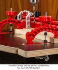 Close-up of Dead Nuts Straight 36 By 36 Inch Drill Press Table Master System with red knuckle clamps holding wood.