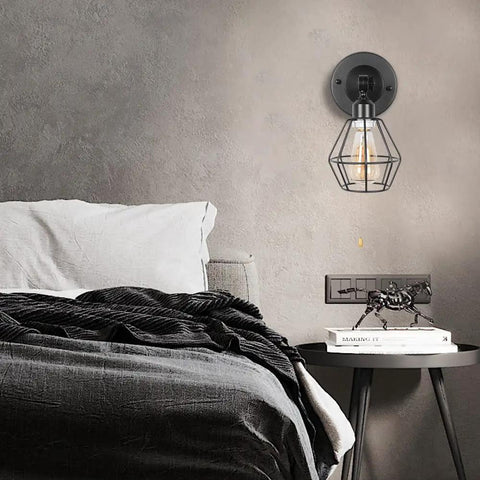 Dope Black Metal Wire Cage Ceiling Light With Pull Chain shown as wall mount near bed with modern decor.
