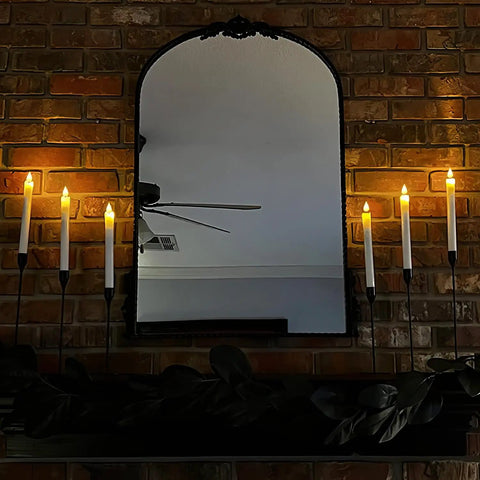 Eight Inch Ivory Flameless Taper Candles With Remote And Timer on a mantel in front of a mirror, showing realistic flickering flame.