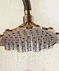 Antique Brass Exposed Shower System with Tub Spout 90° Rotating shower head with intricate pattern and water flow.