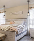 Farmhouse Pendant Lighting Mini Rustic Hanging Light with Seeded Glass Shade in cozy bedroom setting with bronze finish.