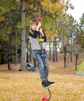 Child playing on 6.56 Foot Climbing Rope Swing With Treads And Plate Swing Hanging Kit For Trees, outdoor usage shown