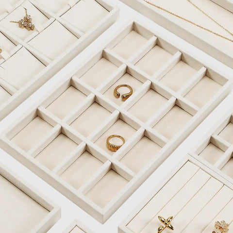 Totally Sweet Beige Linen Jewelry Display Tray With Sixteen Grid Slots For Rings Necklaces And Bracelets Ultra Soft Fabric Organizer showcasing individual compartments filled with rings.