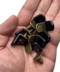 Glass Shelf Pegs In Bronze Tone Antique Bronze Finish For Cabinets Closets And Bookcases Bracket Style Pegs With Rubber Sleeve Six Millimeter One Quarter Inch Size Includes Thirty Pack held in hand