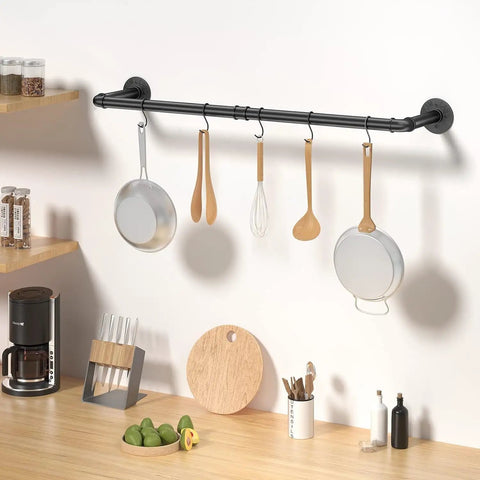 Built Like A Tank Wall Mounted Clothes Rack 3 Pack Black Industrial Pipe Garment Rail with kitchen utensils hanging.