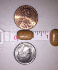 Iron Boost High Potency 106Mg Elemental Iron From 325Mg Ferrous Fumarate pill next to penny and dime for size comparison.