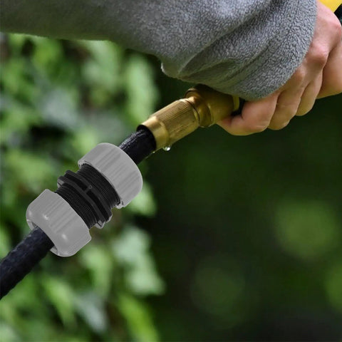 Get Your Garden Hose Back In Action With This Sturdy 4 Piece Repair Kit Featuring Quick Connect Adapters That Make Installation A Breeze For Watering Plants And Keeping Everything Leak Free. Gray plastic hose repair connector on black hose, close-up