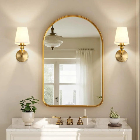 Onwecen Wall Sconces Set of 2, Modern Bathroom Light Fixtures, Brushed Gold beside a round mirror in a stylish bathroom.