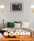 Modern Glass Globe Shade Wall Sconce in Brass Finish beside bed, 6.5 Inch Plug Cable, living room setting, 1 Pack visible