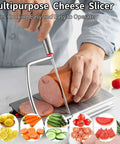 Front view of stainless steel multipurpose cheese slicer with grid and anti-slip pads for slicing cheese, butter.