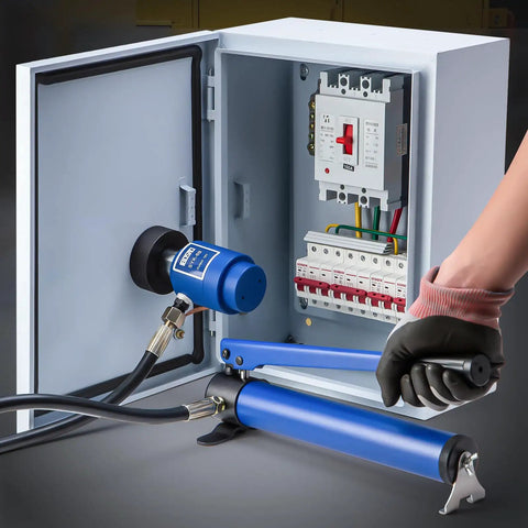 80K Hydraulic Knockout Punch Kit in use, punching a hole in an electrical panel, with blue hydraulic pump and conduit tool.