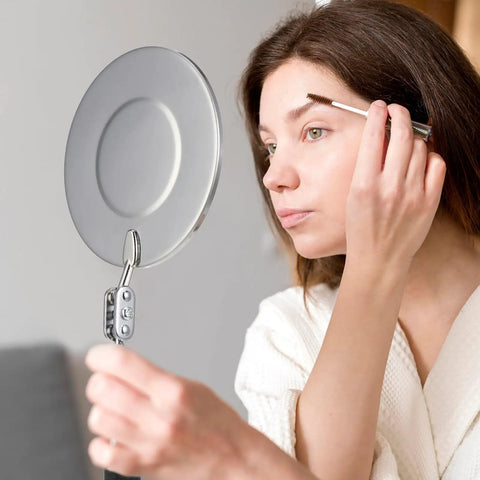 Woman using telescoping inspection mirror for close-up detail work