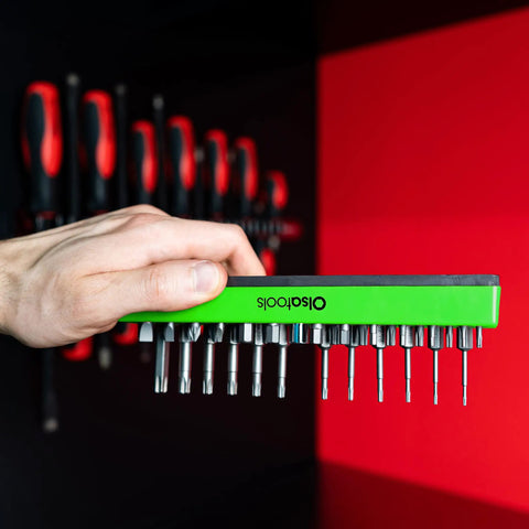 Magnetic Hex Bit Organizer Tray With Green Base Holds 37 One Quarter Inch Bits shown mounted with bits in hand for easy access.