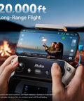 Close-up of Pro Grade Drone With 48MP 8K Photo Sensor showing 20,000 ft range on remote display by a campfire