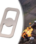 High Carbon Steel Fire Starter Striker next to campfire scene, durable survival gear for outdoor kits, 8x4x0.5 cm, portable with keychain