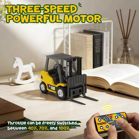 Mini RC Forklift 1 to 64 Scale Alloy Toy with App Programmable Path and Bluetooth Remote Control on desk with remote and books
