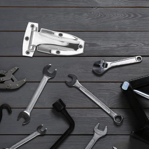 Built Tough Stainless Steel Box Truck Hinges Cargo Trailer Rear Door Hardware on wooden surface with tools.