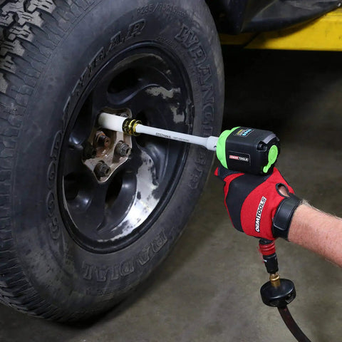 Mechanic using Torque Sticks Half Inch Drive Set Five Piece Torque Limiting Extensions for lug nut protection on a wheel.