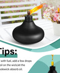 Black metal torch from Six Pack Metal Table Top Torches For Outdoor Use Citronella Fueled Refillable Flame Lights With Wicks And Covers Garden Decor Patio Party Lanterns Landscape Lighting DIY Friendly, displayed on a table