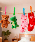 Legit Heavy Duty Colorful Plastic Clothespins With Killer Non Slip Grip And Dang Strong Springs For No Sweat Laundry Hanging Towels And Craft Projects 48 Pack holding plush toys and socks on a rope.