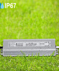 Heavy Duty 60W 24V DC Waterproof LED Driver Power Supply IP67 on grass with water droplets, showing durability