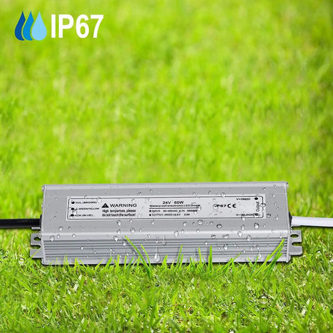 Heavy Duty 60W 24V DC Waterproof LED Driver Power Supply IP67 on grass with water droplets, showing durability