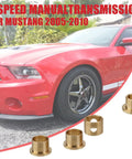Five Piece Shifter Bushing Kit Direct Fit For Ford Mustang 2005 2010 TR3650 T5 WC Bronze Bushings Delivers Smooth Shifts And Tight Gear Feel For V6 And GT Durable Bronze Construction, bronze shifter bushings beside a red 2005-2010 Mustang