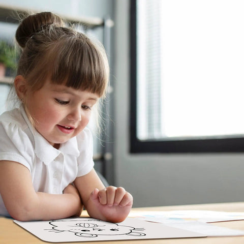 Child using Six Pack Double Sided 9x12 Whiteboards With Lined Surfaces For Kids And Classroom Use, smiling while writing