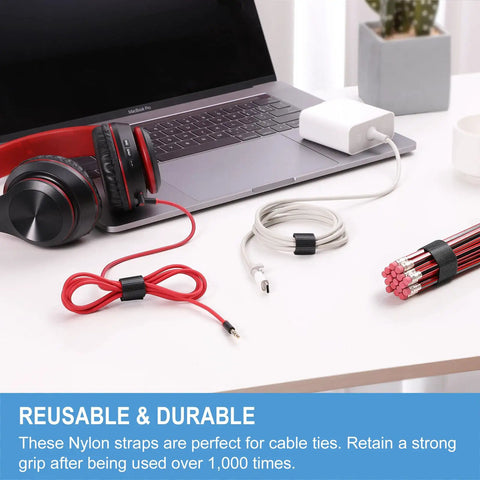 One Inch By Thirty Foot Hook And Loop Tape Roll Featuring Heavy Duty Fabric Straps With Slick Self Adherence Cut To Any Size For No Sweat Cable Wrapping And Garage Gear Management used to secure cables on a desk.