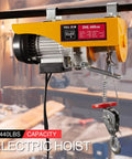 Electric Hoist 1320 Lbs Winch With Remote Control 110V Lift System in garage setting, close-up view of hoist on rail.