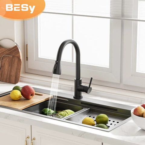 Brass Single Handle Kitchen Faucet With Pull Down Sprayer Matte Black High Arc Sink Faucet with water flowing over fruit
