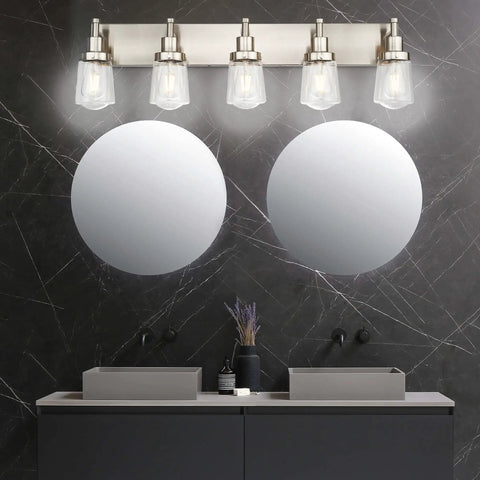 Five Light Brushed Nickel Vanity Light Fixture With Clear Glass Shade Over Mirror For Bathroom