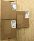 Three sealed cardboard boxes with labels containing information about the Model 4603-9101 LCD Annunciator Display Panel.