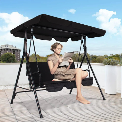 Woman sitting on Three-Seat Outdoor Patio Swing Chair with Adjustable Canopy and Durable Steel Frame for Patio Garden and Poolside Black Finish, ideal for backyard kickback and hangouts.