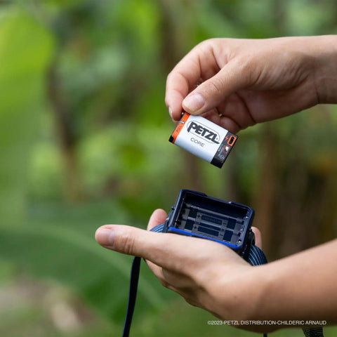 Inserting Core Rechargeable Battery For Hybrid Headlamps 1250 mAh Li Ion With USB Micro USB Port into headlamp outdoors
