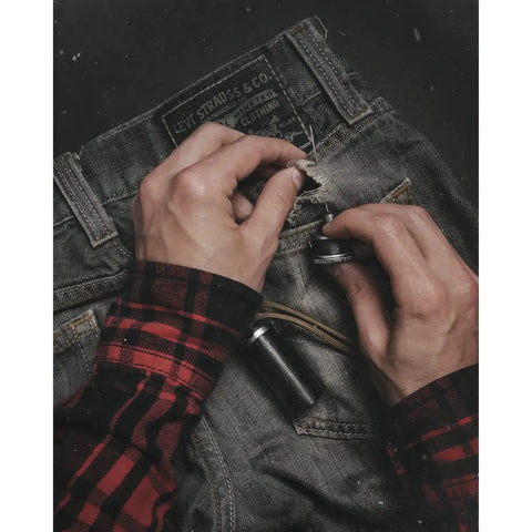 Hands repairing jeans with Rip Spool Field Repair Kit Orange For On The Go Fixes Your Must Have Outdoor Gear Upgrade With Quick Fix Tools