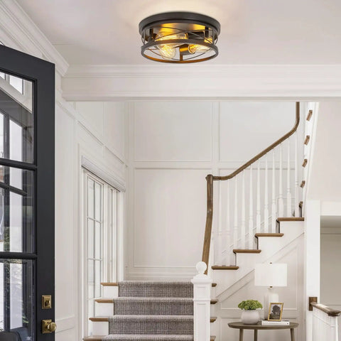 Farmhouse Black 3 Light Flush Mount Ceiling Fixture With Metal Cage Shade in foyer, showing vintage industrial design, E26 base.