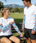 Stay Fresh With These Dope Cooling Arm Sleeves Shielding Bold Tattoo Ink Under Blazing Sun While You Crush Cycling Or Fishing Trips Quick Drying Stretch Polyester Delivers Solid UV Protection Daily worn by couple outdoors.