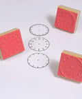 Totally Sweet Wooden Analog Clock Stamp Set For Kids Learning To Tell Time With Teachers And Parents Super Handy For Craft Projects and Classroom Fun No Hands Design Makes Teaching A Breeze, featuring red rubber clock stamps and clock face images.