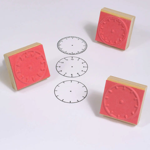 Totally Sweet Wooden Analog Clock Stamp Set For Kids Learning To Tell Time With Teachers And Parents Super Handy For Craft Projects and Classroom Fun No Hands Design Makes Teaching A Breeze, featuring red rubber clock stamps and clock face images.