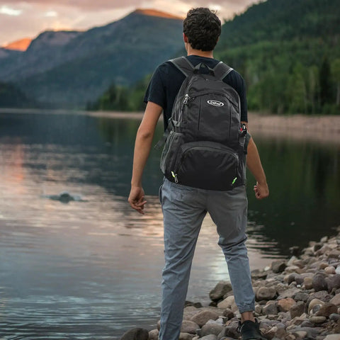Person with 40L Lightweight Packable Hiking Backpack With Wet Pocket Waterproof Daypack For Travel Camping And Outdoor Adventures