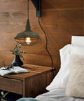 Farmhouse Plug In Pendant Light With 16 Feet Hanging Cord And Wire Cage Shade In Dark Charcoal Gray Finish in bedroom setting