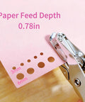 Close-up of 2 Pack Mini Circle Hole Punches One Quarter Inch And One Eighth Inch With Pink Soft Grip Handles used on pink paper