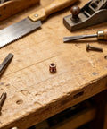 M6x10mm Countersunk Flange Wood Nut Inserts for Cabinets and Desks on wooden workbench with tools