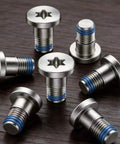 Straightup Replacement Screw Kit For Ray Ban Meta And Oakley Meta Smart Glasses Temple Hinge Repair Gen 1 Gen 2 screws arranged on wooden surface.