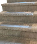 Close-up of Clear Stair Tread Protectors Set Of 2 24 X 8 Inches Slip Resistant Vinyl Treads With Gripper Teeth on carpeted stairs
