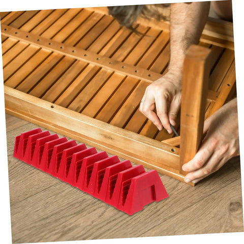 Space Saving Wrench Rack Organizer For Garage And Workshop 12 Piece Tool Organizer Tray Labeling Wrench Storage Holder To Speed Up Finding The Right Tool Heavy Duty Wrench Sorter And Wall Mount, red holder on floor with assembly task in background.
